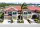 Three-unit townhome building with Spanish tile roofs and attached garages at 228 Crew Ct, Sarasota, FL 34243
