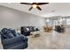 Open living room with a navy sectional sofa and tiled floors at 228 Crew Ct, Sarasota, FL 34243
