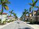 Residential street lined with townhouses and palm trees at 228 Crew Ct, Sarasota, FL 34243