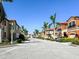 Townhouses with red tile roofs and palm trees line a residential street at 228 Crew Ct, Sarasota, FL 34243