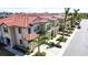 Aerial view of townhouses with red tile roofs and lush landscaping at 228 Crew Ct, Sarasota, FL 34243