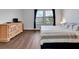 Main bedroom with a dresser, large bed, and dark flooring at 228 Crew Ct, Sarasota, FL 34243
