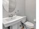 Convenient powder room with pedestal sink and toilet at 228 Crew Ct, Sarasota, FL 34243