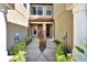Townhouse entry with walkway, landscaping, and double door entry at 228 Crew Ct, Sarasota, FL 34243
