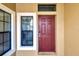 Front door entry with a burgundy door and sidelights at 228 Crew Ct, Sarasota, FL 34243