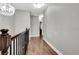 Upper level hallway featuring wood-look flooring and neutral walls at 228 Crew Ct, Sarasota, FL 34243