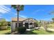 Front view of charming one-story house with palm trees at 1320 W Corktree Cir, Port Charlotte, FL 33952