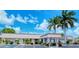 Community building exterior view, featuring landscaping and parking at 2020 Riverbluff Pkwy # V329, Sarasota, FL 34231