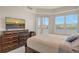 Main bedroom with large dresser and water views at 10520 Boardwalk Loop # 301, Bradenton, FL 34202