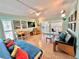 Spacious living area with comfortable seating and access to balcony at 2850 Gulf Of Mexico Dr # 2, Longboat Key, FL 34228