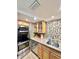 Modern kitchen with stainless steel appliances and mosaic backsplash at 2850 Gulf Of Mexico Dr # 2, Longboat Key, FL 34228