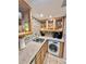 Well-equipped kitchen corner with washer, dryer, and coffee maker at 2850 Gulf Of Mexico Dr # 2, Longboat Key, FL 34228