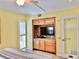 Bedroom with built-in entertainment center and TV at 2850 Gulf Of Mexico Dr # 2, Longboat Key, FL 34228