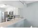 Kitchen boasts white cabinets, stainless steel appliances, and a breakfast bar at 408 Cerromar S Cir # 130, Venice, FL 34293