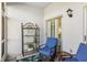 Enclosed patio with wicker chairs and a shelving unit at 408 Cerromar S Cir # 130, Venice, FL 34293