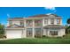 Two-story home with light beige siding and a gray roof at 2477 Waterfront Cir, Sarasota, FL 34240