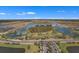 Aerial view of a community with a lake and lush landscaping at 2477 Waterfront Cir, Sarasota, FL 34240