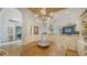 Bright dining area with a round wooden table and unique chairs at 328 Woods Point Rd, Osprey, FL 34229
