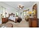 Spacious bedroom with a king-size bed and wood furniture at 7642 Tralee Way, Bradenton, FL 34202