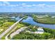 Scenic aerial view of a winding river, featuring a bridge, lush greenery, and the surrounding landscape at 1111 143Rd Ne St, Bradenton, FL 34212