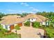 Luxury home with a tile roof, two-car garage, and meticulously landscaped grounds at 1111 143Rd Ne St, Bradenton, FL 34212