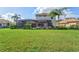 Expansive backyard featuring a large grassy area and a beautiful home with a pool at 1111 143Rd Ne St, Bradenton, FL 34212