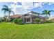 Sprawling backyard features a screened-in pool, lush landscaping, and well-manicured lawn for outdoor enjoyment at 1111 143Rd Ne St, Bradenton, FL 34212