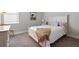 Cozy bedroom with plush carpet, a queen-sized bed, and natural light from the window at 1111 143Rd Ne St, Bradenton, FL 34212