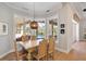 Bright breakfast nook with pool view and wooden table and chairs at 1111 143Rd Ne St, Bradenton, FL 34212
