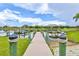 Lakeside dock featuring a boat lift and waterfront views on a sunny day at 1111 143Rd Ne St, Bradenton, FL 34212