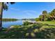 Picturesque waterfront view with a dock on a tranquil river, surrounded by lush greenery and mature trees at 1111 143Rd Ne St, Bradenton, FL 34212
