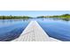 Beautiful waterfront view with a long wooden dock extending into the calm river at 1111 143Rd Ne St, Bradenton, FL 34212