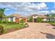 Stunning home with a paver driveway, three-car garage, and well-manicured landscaping at 1111 143Rd Ne St, Bradenton, FL 34212