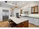 Modern kitchen with stainless steel appliances, an island with seating, and custom cabinetry at 1111 143Rd Ne St, Bradenton, FL 34212