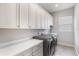 Laundry room with washer, dryer, and white cabinets at 1111 143Rd Ne St, Bradenton, FL 34212