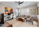 Bright living room with neutral paint, plantation shutters, and a ceiling fan at 1111 143Rd Ne St, Bradenton, FL 34212