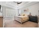 Serene primary bedroom featuring a tray ceiling, plantation shutters, and plush carpeting at 1111 143Rd Ne St, Bradenton, FL 34212