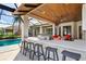 Outdoor kitchen with bar seating and pool view at 1111 143Rd Ne St, Bradenton, FL 34212