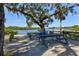 Scenic picnic area near the waterfront, featuring picnic tables, a grill, and shady trees at 1111 143Rd Ne St, Bradenton, FL 34212