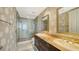 Stylish bathroom with double sinks, marble countertops, and a glass-enclosed shower at 1233 N Gulfstream Ave # 1001, Sarasota, FL 34236