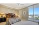 Cozy bedroom with a balcony, neutral tones, and scenic city views at 1233 N Gulfstream Ave # 1001, Sarasota, FL 34236