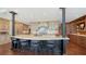 Gourmet kitchen featuring a large island, bar seating, custom cabinets, and hardwood floors at 1233 N Gulfstream Ave # 1001, Sarasota, FL 34236