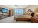 Elegant main bedroom with a water view, a balcony, and sophisticated furnishings at 1233 N Gulfstream Ave # 1001, Sarasota, FL 34236
