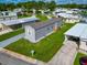Mobile home with landscaped lot in a 55+ community at 6421 Kilohee Ct, North Port, FL 34287