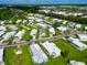 Mobile home community with lush landscaping and ample space at 6421 Kilohee Ct, North Port, FL 34287