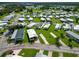An aerial view of a mobile home community, showing a variety of homes and green spaces at 6421 Kilohee Ct, North Port, FL 34287