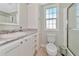 Clean bathroom with white vanity, shower, and toilet at 6421 Kilohee Ct, North Port, FL 34287