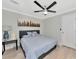 Bright bedroom with ceiling fan, light gray walls, and a comfortable queen-size bed at 6421 Kilohee Ct, North Port, FL 34287