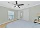 Comfortable bedroom with ceiling fan and large window at 6421 Kilohee Ct, North Port, FL 34287