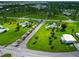 Aerial view of community entrance with lush landscaping and fountains at 6421 Kilohee Ct, North Port, FL 34287